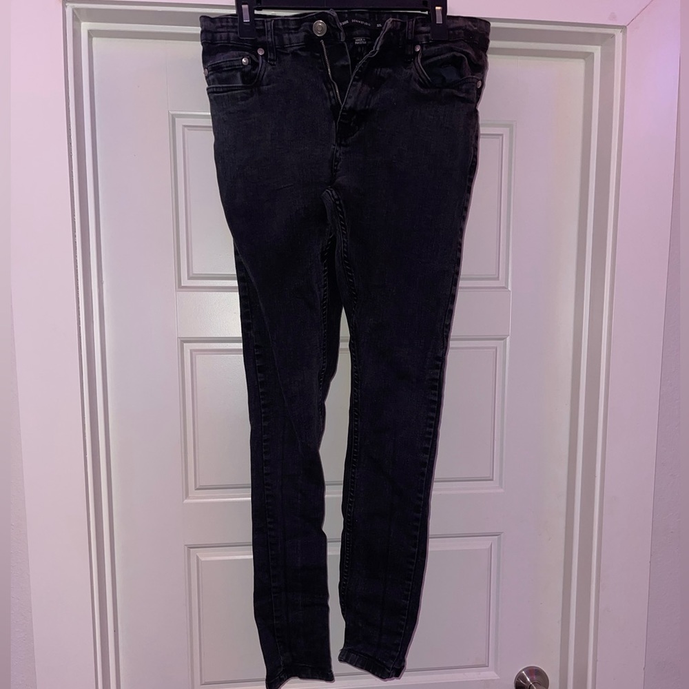 Worn black skinny jeans.